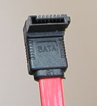 A seven-pin SATA data cable (upward-angled version of the connector)