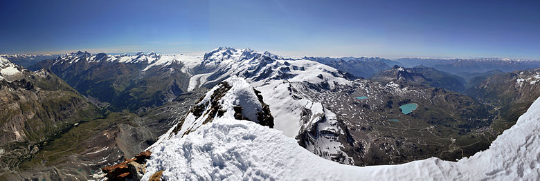 Monte Rosa viewed from the summit of the Matterhorn (centre), with the valleys of Mattertal (left) and Valtournenche (right) alongside it