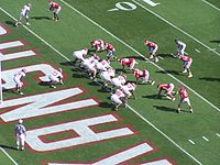 American football players line up in a goal line formation.