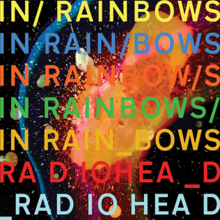 The album title written several times in different colours, featuring a splatter of fiery orange colour in the background, with the artist name at the bottom twice.