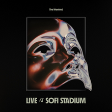 The cover depicts an iridescent mask facing the upper right side, inside a rectangle. The background is a grainy black, the the artist's name on top and the album title on the lower part.