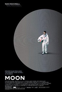 Standing alone, an astronaut holds his helmet in his hand.