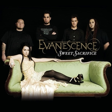 A picture showing five people in a black room. The woman in front has black hair and a yellow dress and is lying on a couch. Four men are shown behind her and all of them are wearing black T-shirts. In front of them, the word "Evanescence" is written with yellow letters. Another word "Sweet Sacrifice" can be also seen which is written in white letters.