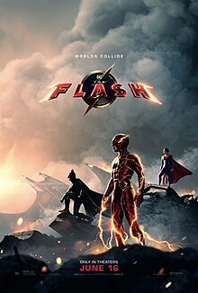 The Flash, surrounded by lightning, standing in a destroyed field with Batman, Supergirl, and the Batwing in the smoky background. The Flash logo and the tagline "Worlds Collide" are displayed above.